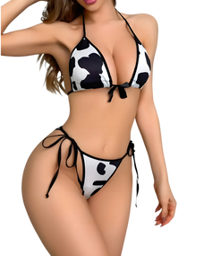 A model wearing a cow print lingerie bra and panty set. A model wearing a cow print lingerie bra and panty set.