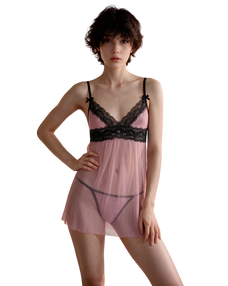 A model wearing a sheer pink babydoll lingerie chemise with black lace trim and black undergarments, set against a plain white background. A model wearing a sheer pink babydoll lingerie chemise with black lace trim and black undergarments, set against a plain white background.