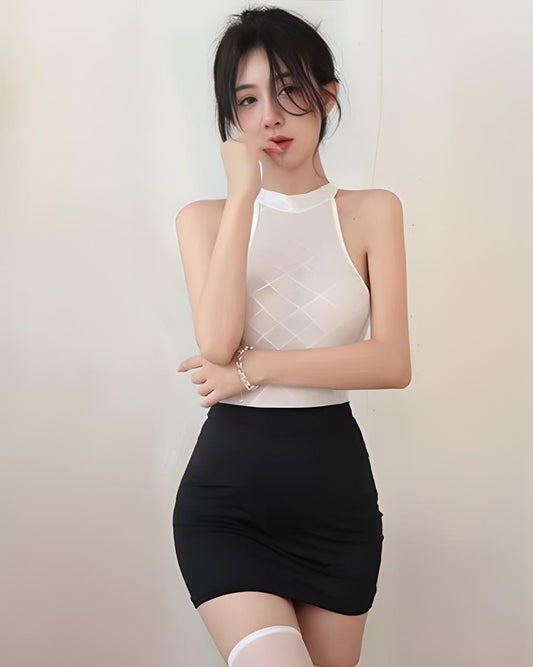 Woman wearing a white top and black skirt against a plain background