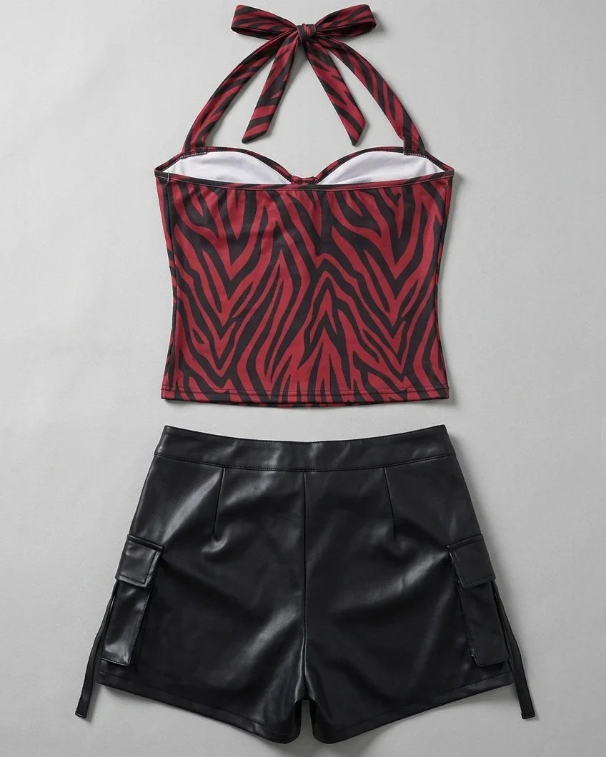 Back flat lay of halter-neck zebra top and black faux leather shorts