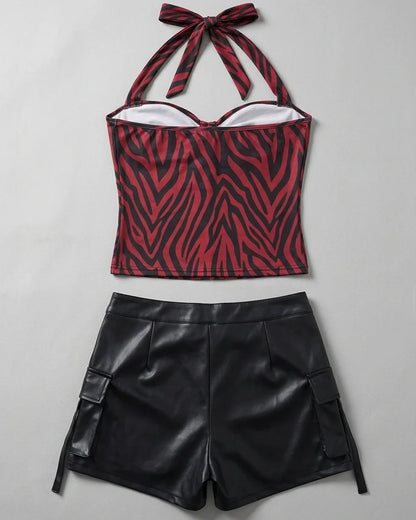 Back flat lay of halter-neck zebra top and black faux leather shorts