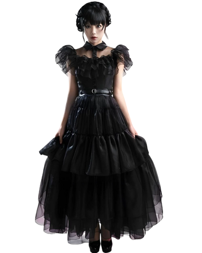Woman wearing a black gothic-style dress on a white background