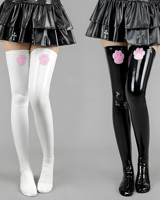 White and black cat paw thigh-high stockings with pink paw prints on a gray background