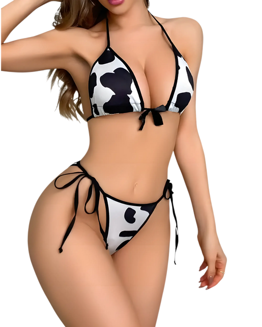 A model wearing a cow print lingerie  bra and panty set.