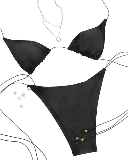 Black bikini set with gold buttons on a white background