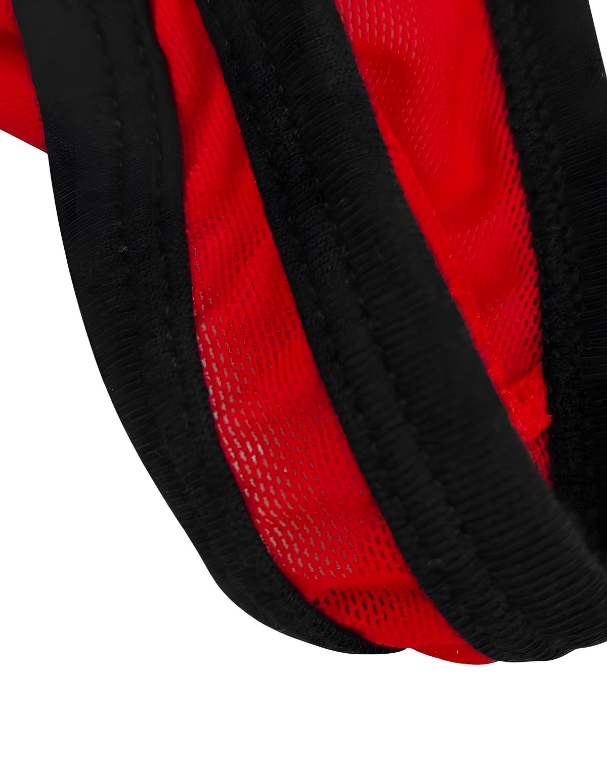 Close-up detail of a red and black striped mesh fabric with thick black trim, shown against a white background.