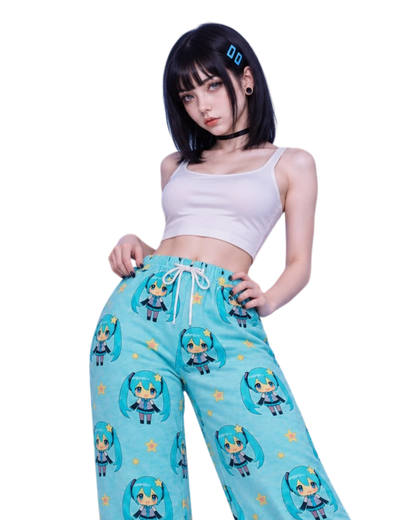 A model wearing light blue wide-leg sweatpants with a repeating chibi Hatsune Miku print, styled with a white crop top against a solid white background.