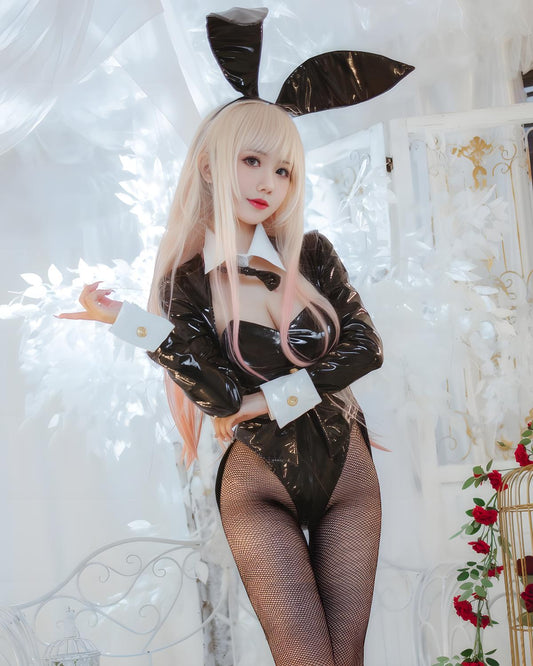 Person in a black and white Marin Kitagawa bunny costume with rabbit ears against a decorative background.