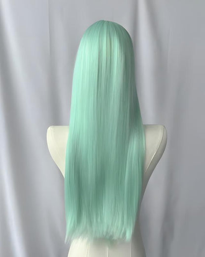 Mint green wig on a mannequin head against a plain background