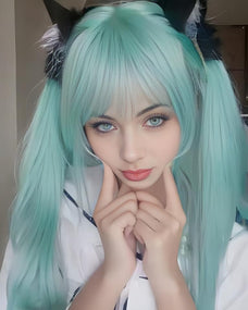Person with teal hair styled in pigtails wearing a white outfit.