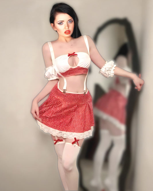 Woman wearing a red and white maid outfit with a blurred background