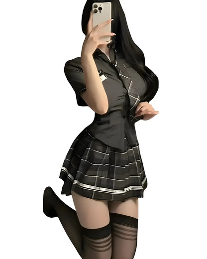 Sexy schoolgirl outfit with pleated mini skirt, a stylish school girl costume for cosplay black sitting on ground