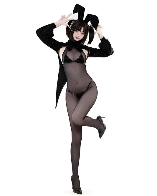 Person wearing a black outfit with sheer elements on a white background