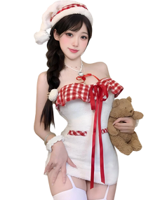 Woman in a festive outfit with a red and white checkered top and white skirt, holding a teddy bear.