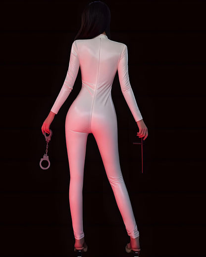 Person wearing a white bodysuit holding handcuffs and a whip on a black background