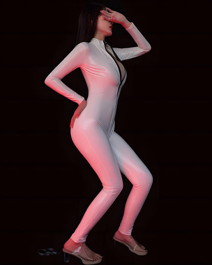 Person wearing a white bodysuit with red lighting on a black background