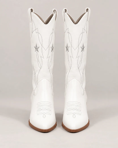 Front view of white star embroidered mid-calf cowboy boots with brown heels
