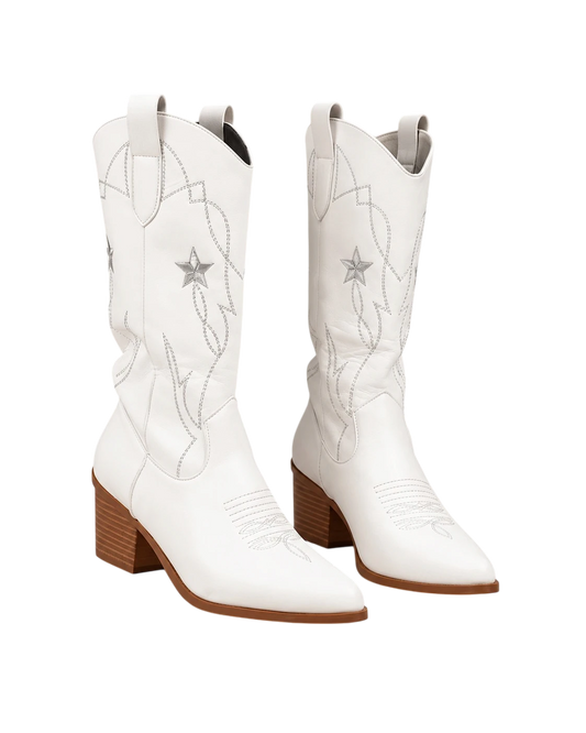 A pair of white leather cowboy boots with silver embroidered western patterns and star details, featuring brown stacked block heels, shown against a plain white background.